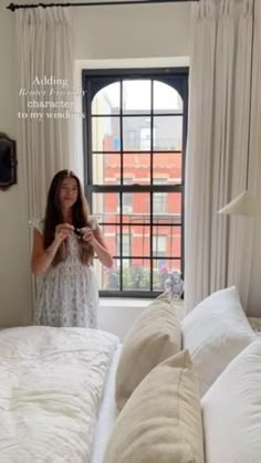 a woman is taking a selfie in her bedroom