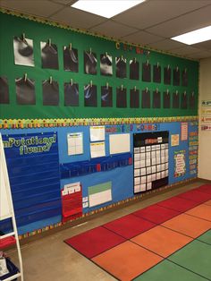 an empty classroom with bulletin boards on the wall