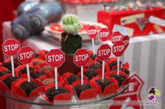 cupcakes with stop signs on them are displayed in front of other desserts