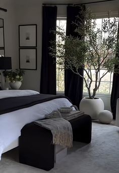 a bedroom with black and white decor in it