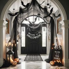 an entrance decorated for halloween with bats and pumpkins