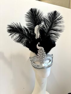 Peacock Masquerade Mask - feather Mask- Wedding - Halloween- Black and white Ball- Mardi Gras Hello,    This is a wonderful peacock mask looks even better in person.  The feathers are  black and silver with a matching mask and stunning peacock silver brooch. colors: Silver and black feathers (shown) Gold and black feathers    This peacock feathers sit on the middle along with feathers. The peacock is 4 inches and the feathers are about 6-8inches long.     It's great for any masked ball, peacock Peacock Masquerade, Gothic Halloween Decorations, Peacock Mask, Black And White Ball, Peacock Costume, Feather Mask, Wedding Halloween, Masked Ball, The Peacock