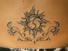 the back of a woman's stomach with a sun and water drops tattoo on it