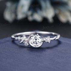 a white gold engagement ring with an arrow and stars on the side, set in 18k white gold