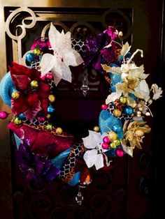 a colorful wreath is hanging on the front door