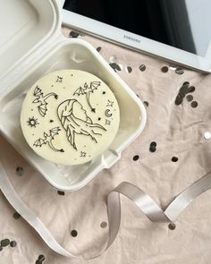 a decorated cookie in a container on a table