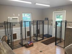 an indoor dog kennel with doors open to allow dogs to use the space for their food