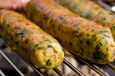 two sausages cooking on an outdoor grill