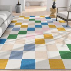 a multicolored rug in the middle of a living room