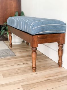 a wooden bench sitting on top of a hard wood floor