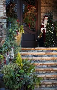 a santa clause is standing on the front steps