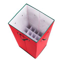 an open red box with compartments and handles on the inside is filled with small pieces of paper