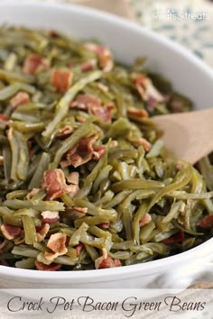 green beans and bacon in a white bowl with a wooden spoon on the side, ready to be eaten