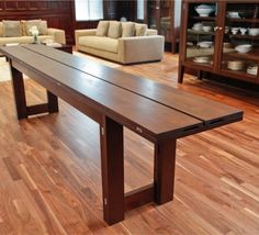 a living room filled with furniture and wooden flooring on top of a hard wood floor