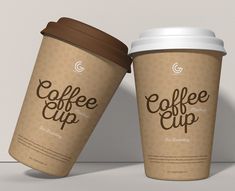 two coffee cups sitting side by side next to each other