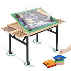 a child's drawing table with three different sections on the top and one being held up by a hand