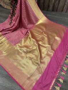 Glamorous Banarsi saree in rogue pink with gold zari butas all throughout and tassels on the palla Fall attached. Matching blouse fabric included. Note: The color of the products may slightly vary according to the ambient lighting conditions and the color calibration of LED devices. If you would like more clarity before your purchase, please drop us a message . Bollywood Style Gold Pre-draped Saree With Pallu, Banarasi Silk Pre-draped Saree For Celebration, Festive Celebration Katan Silk Pre-draped Saree, Gold Anarkali Banarasi Silk Pre-draped Saree, Traditional Gold Pre-draped Saree With Self Design, Pink Bollywood Pre-draped Saree With Meenakari, Traditional Gold Pre-draped Saree For Navratri, Eid Celebration Pre-draped Saree With Zari Weaving, Semi-stitched Gold Banarasi Silk Traditional Wear