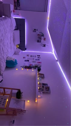 a bedroom with purple lights on the walls and floor