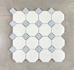 a white tile with blue flowers on it