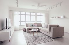 a living room filled with furniture and a flat screen tv