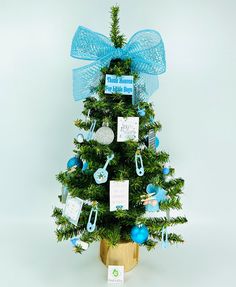 a small christmas tree decorated with blue ornaments