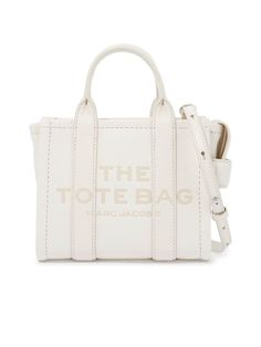 * Colour: White
   
 * Composition: 100% cow leather
   
   
   
 * Year: 2024
   
   
   
 * Made in: Vietnam
   
   
   
 * Style ID: 242445ABS000006-140
   
   
   
 * Measurements:
   Width: 18cm x Height: 15cm x Depth: 9cm
   Shoulder strap length: 115cm
   Handle drop: 8cm
   
   
   

A quintessential accessory for the modern woman, this Leather Mini Tote Bag
exudes urban chic. Meticulously crafted with grained leather, the tote makes a
statement with its bold contrasting logo. The design is practical yet stylish,
featuring double handles paired with a detachable and adjustable shoulder strap
for versatile carrying options. A side handle and top zipper closure ensure ease
of access, while the unlined interior and sleek silver-tone metalware add an air
of sophistication. It's an idea Lettering Logo, Mini Tote Bag, Marc Jacobs Bag, The Tote Bag, Strap Top, Crossbody Tote, Mini Tote, Leather Mini, White Bag