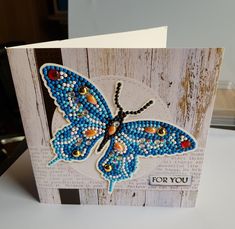 a card with a blue butterfly on it and the words for you written in beads