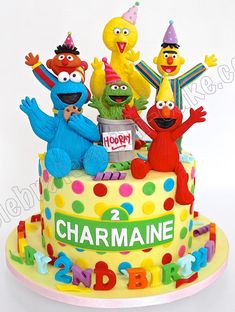 a birthday cake with sesame street characters on it