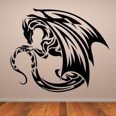 a black and white dragon wall decal on a wooden floor in an empty room