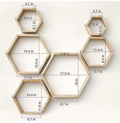 three wooden hexagons are shown with measurements for each one on the wall