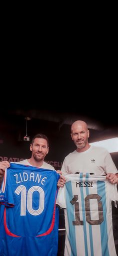 two men holding up jerseys in front of a black background with the number ten on it