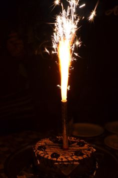 a birthday cake with a sparkler on top