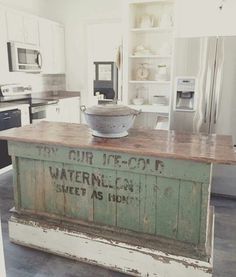 an old kitchen island with a sign on it