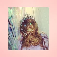 a girl with long hair wearing a tiara