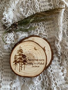 two slices of wood that have been engraved with the names of trees and moon on them