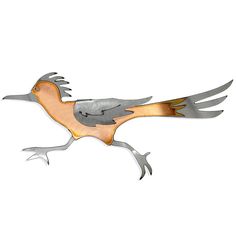 a metal bird flying through the air on a white background