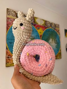 a crocheted doughnut with a pink frosting and sprinkles on it