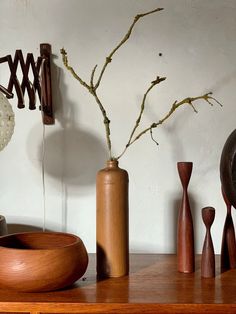 a wooden table topped with vases and sculptures