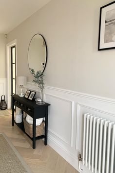 there is a black table with a mirror on it next to a radiator