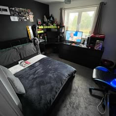 a bed room with a neatly made bed next to a window and a television set