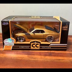 a gold die cast car in a box