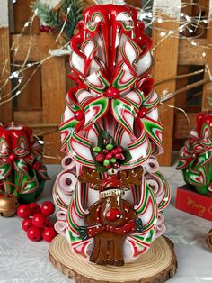 a christmas tree made out of candy canes and other holiday decorations on a table