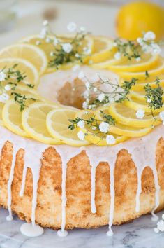 a cake with lemons and white icing on it