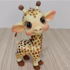 a small giraffe toy sitting on top of a wooden table