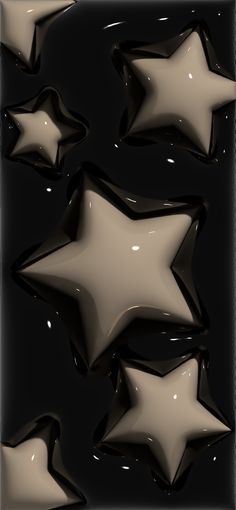 several shiny stars are in the air on a black background with white and brown highlights