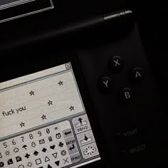 a close up of a remote control with buttons and symbols on the screen in front of it