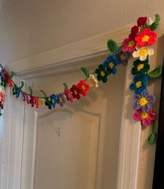 there are crocheted garlands hanging on the wall above the door way in this house