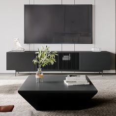 a living room with a large television on the wall and a black coffee table in front of it