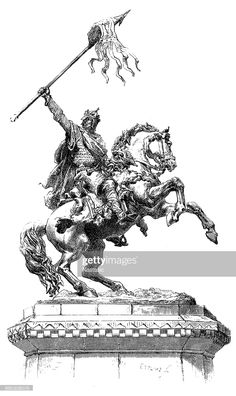 a statue of a man riding on the back of a horse with a spear in his hand