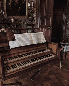 an old piano with sheet music on it